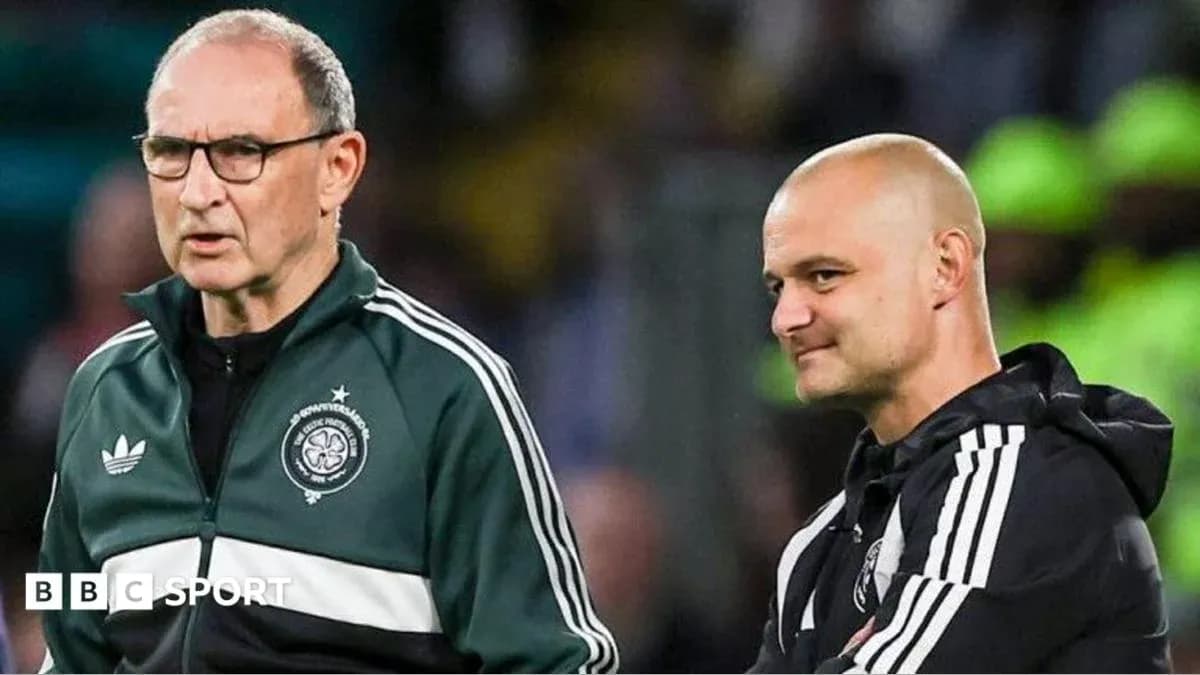 Two football coaches discussing on the sidelines Two football coaches discussing on the sidelines