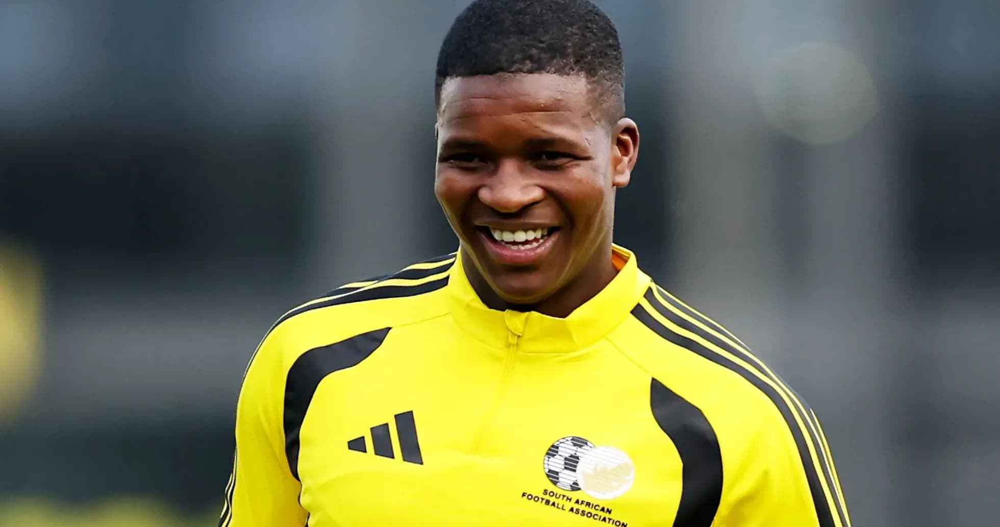 Player smiling in yellow training kit Player smiling in yellow training kit