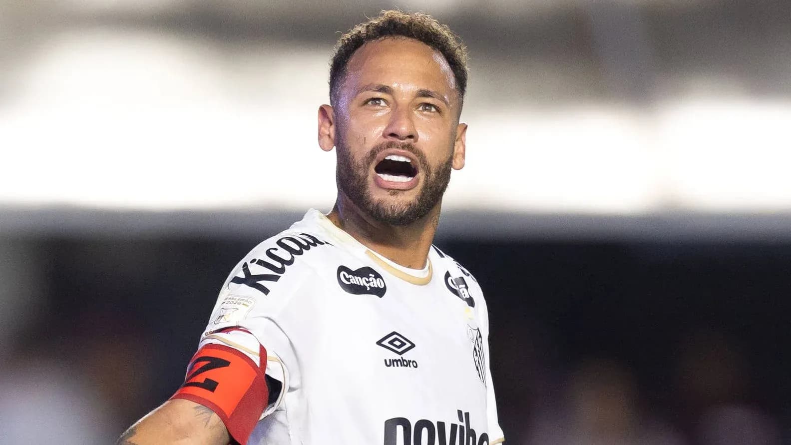 Player celebrating with captain's armband on field Player celebrating with captain's armband on field