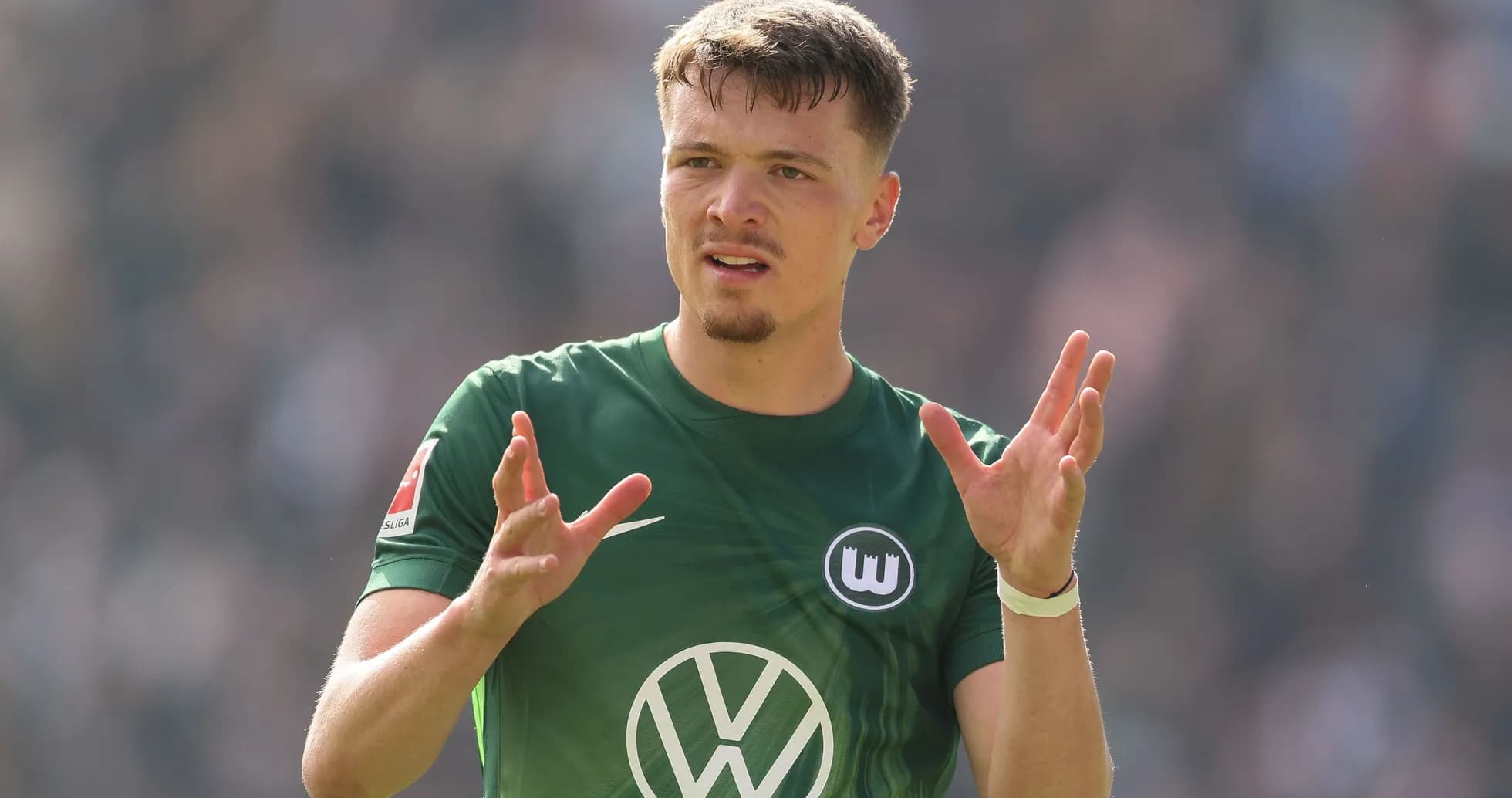 Player gesturing during match in green jersey Player gesturing during match in green jersey