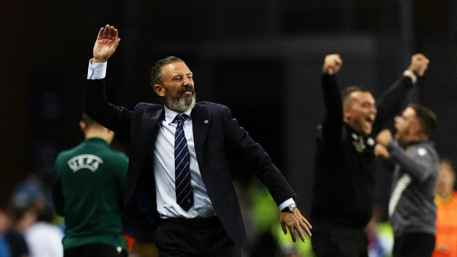 Coach celebrating with raised hand during match Coach celebrating with raised hand during match