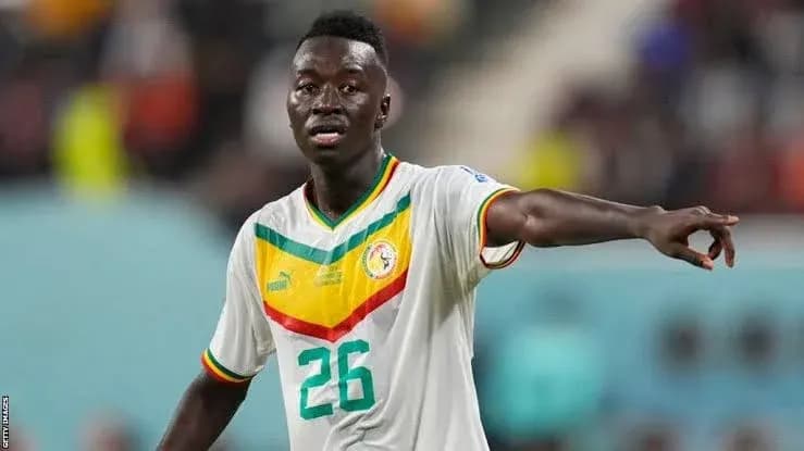 Player in Senegal national team jersey directing play Player in Senegal national team jersey directing play