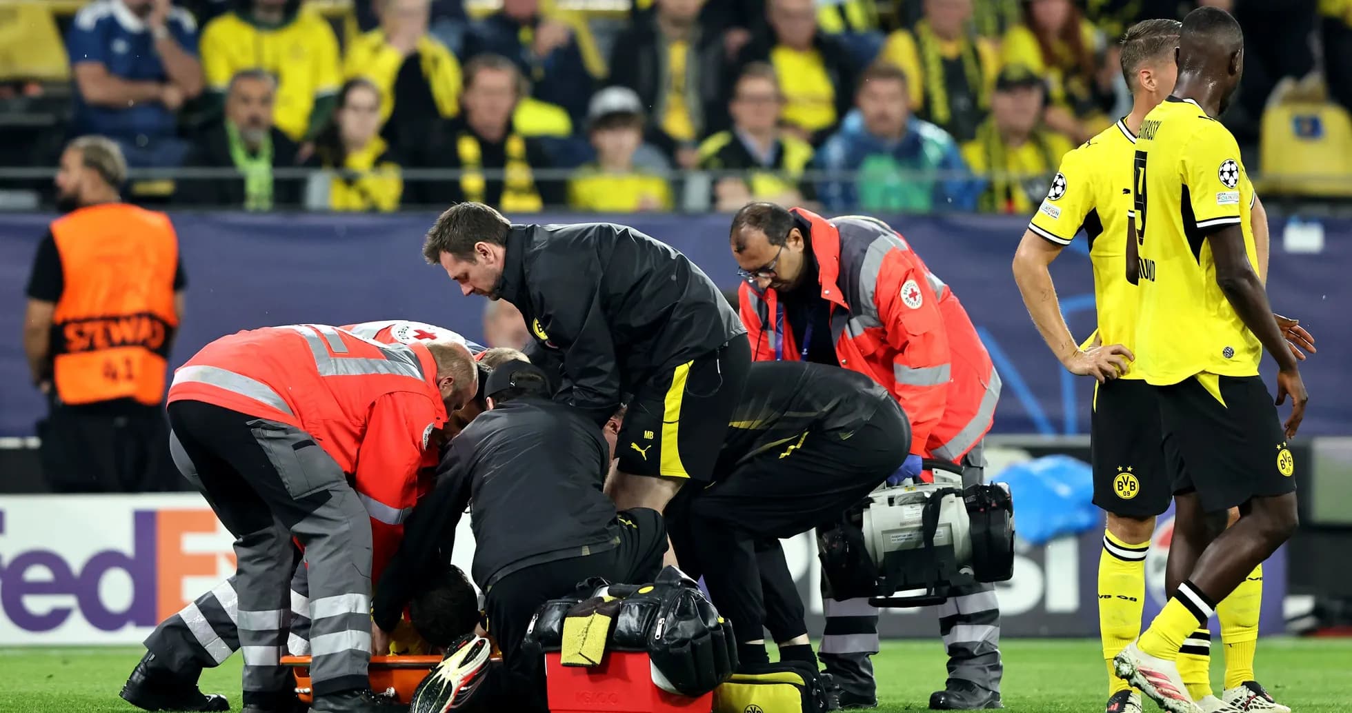 Medical staff attending to player on the field Medical staff attending to player on the field