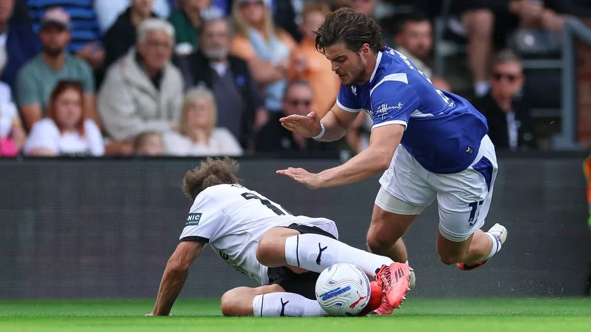 Player tackling opponent on the pitch during match Player tackling opponent on the pitch during match