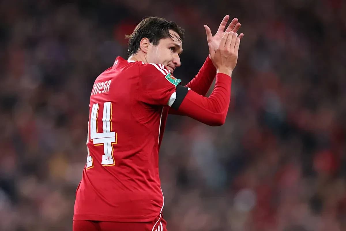 Player in red jersey applauding fans during match Player in red jersey applauding fans during match