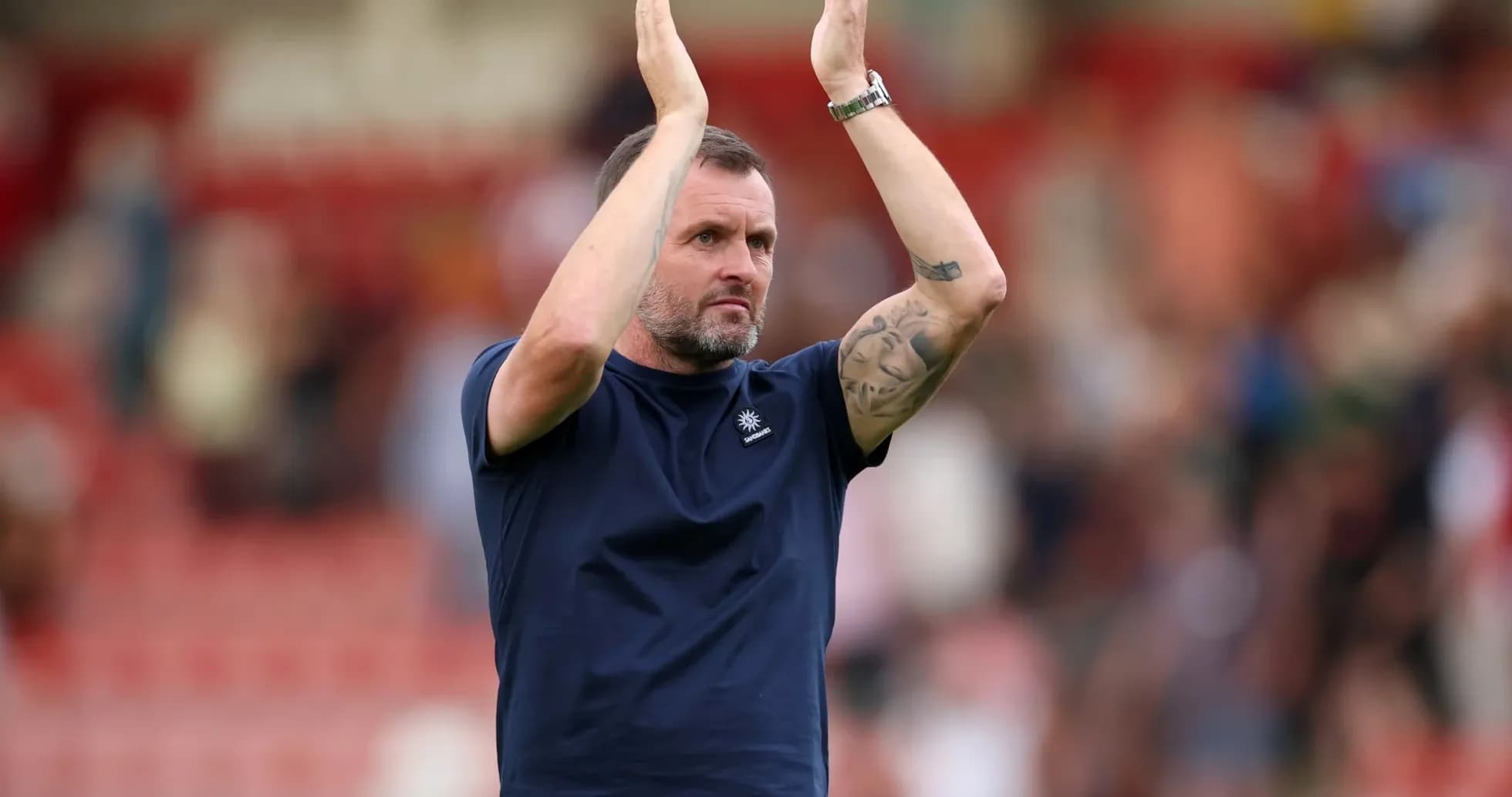 Coach applauding fans after a match Coach applauding fans after a match