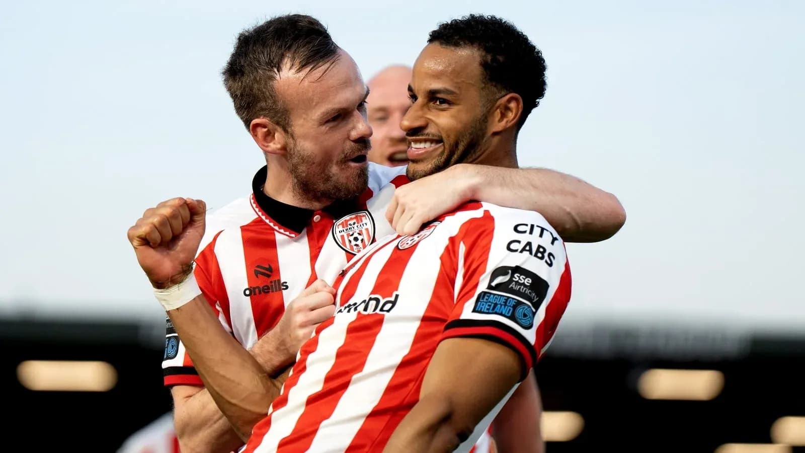 Two players celebrating a goal on the field Two players celebrating a goal on the field