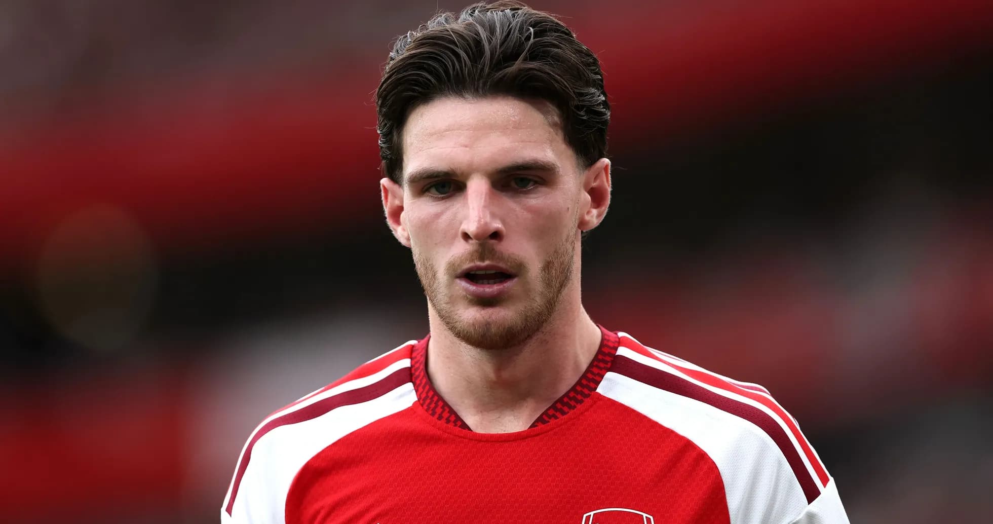 Arsenal player in red jersey on the pitch Arsenal player in red jersey on the pitch