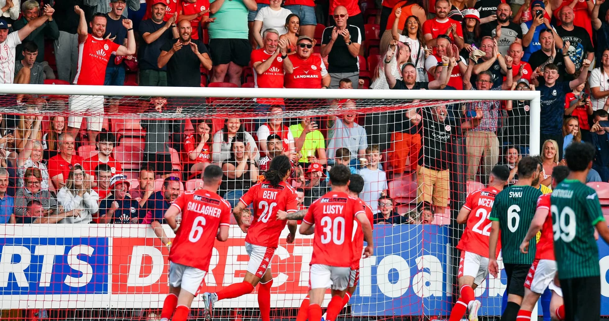 Larne players celebrating a goal during match Larne players celebrating a goal during match