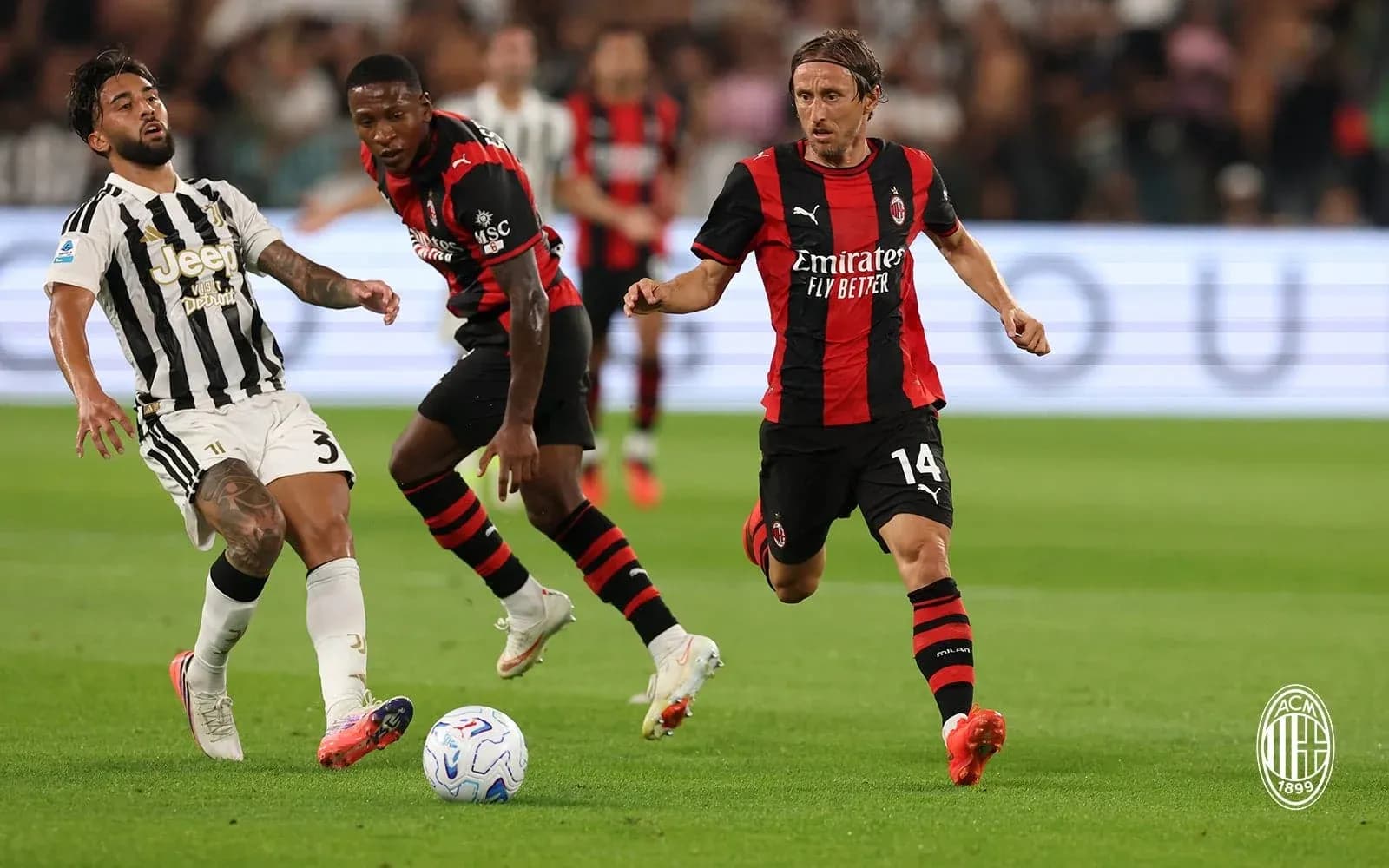 Juventus and AC Milan players competing for the ball Juventus and AC Milan players competing for the ball