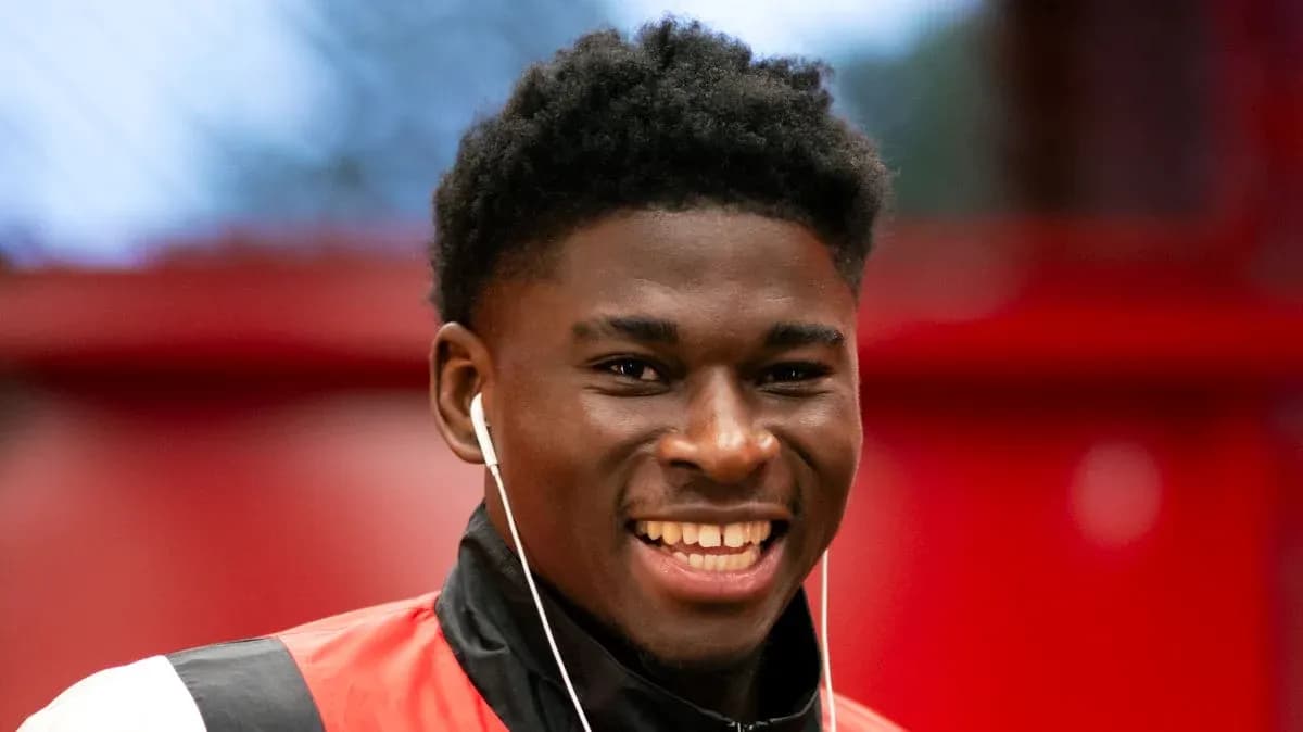 Player smiling while wearing headphones indoors Player smiling while wearing headphones indoors