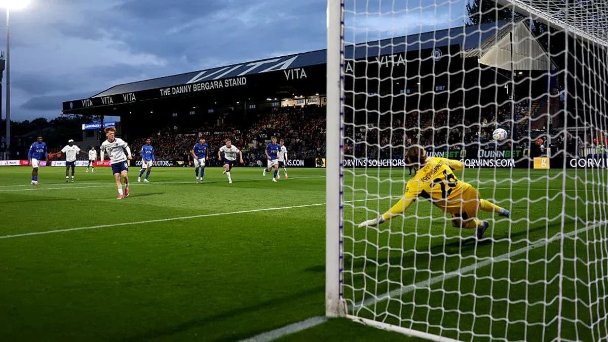 Player taking penalty kick while goalkeeper dives Player taking penalty kick while goalkeeper dives