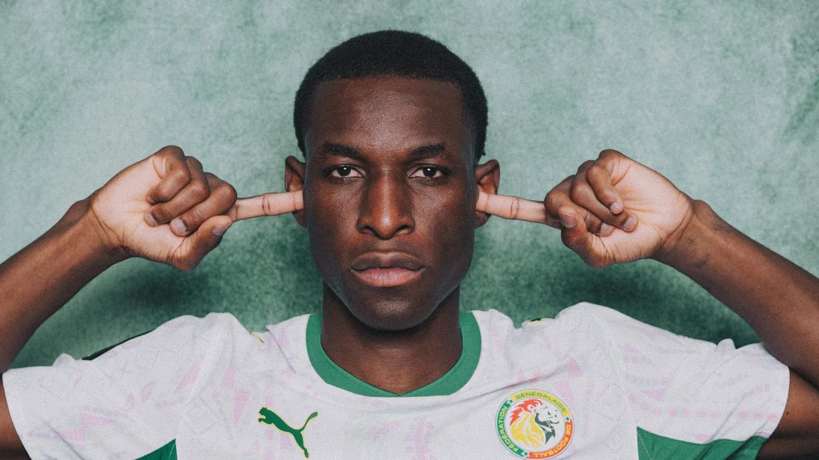 Player covering ears in Senegal national team jersey Player covering ears in Senegal national team jersey