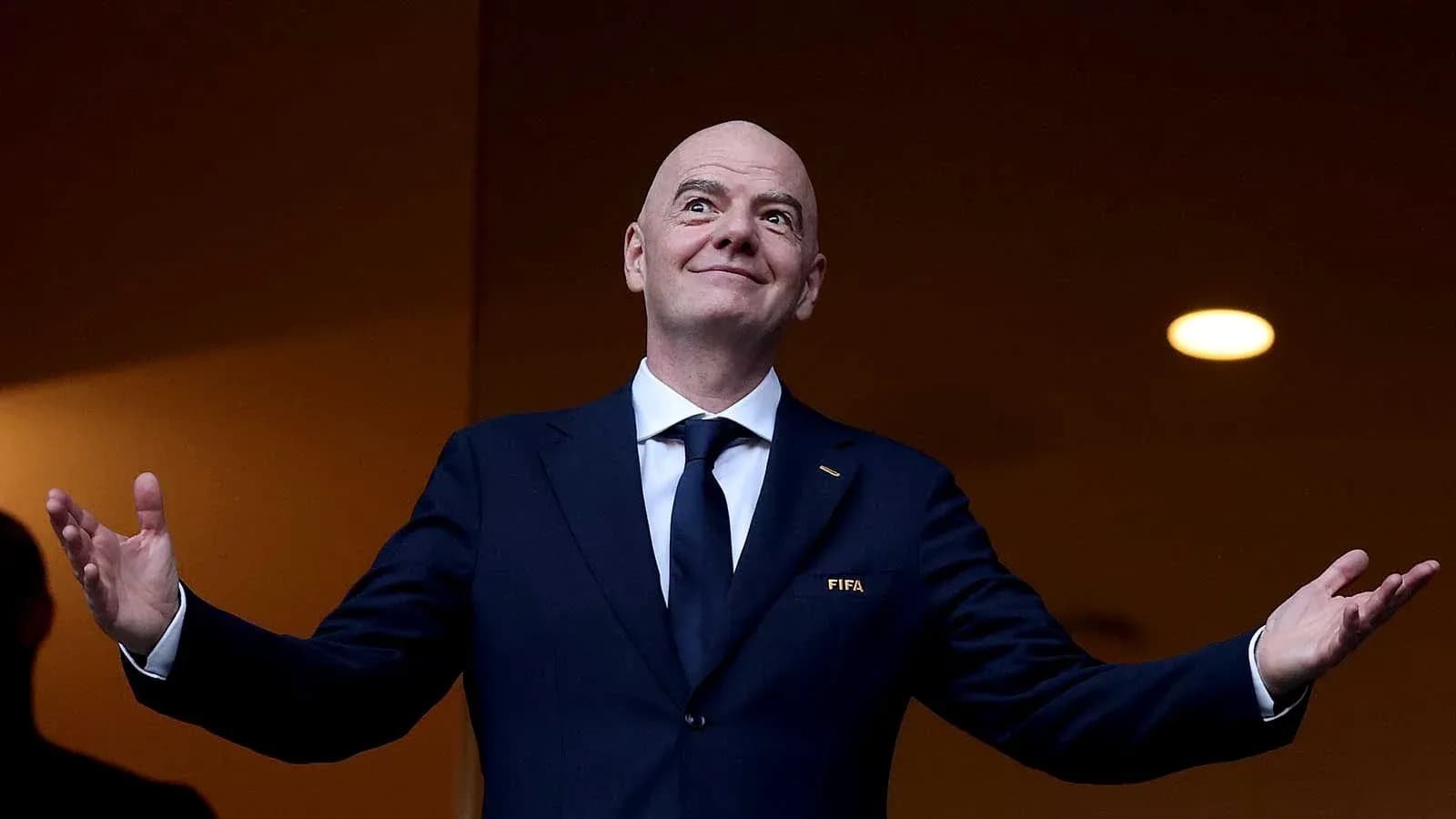 Man in suit gesturing during event or speech Man in suit gesturing during event or speech