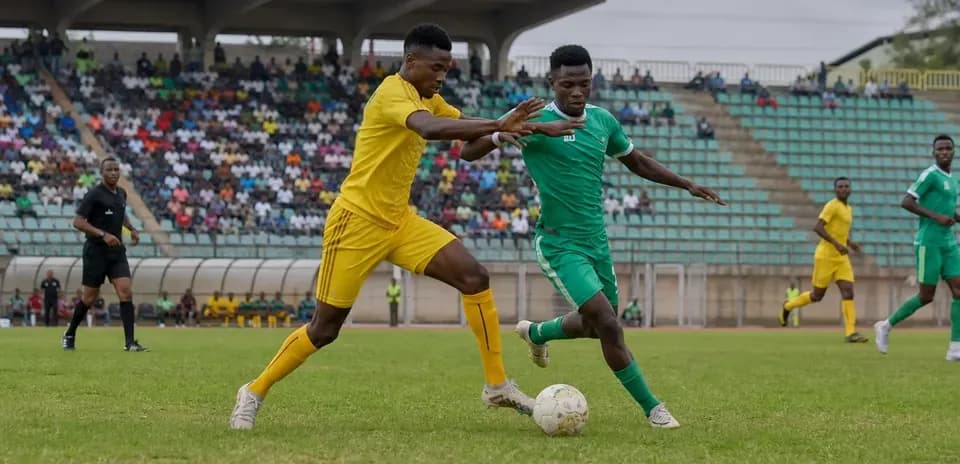 Players competing for the ball in CAF match Players competing for the ball in CAF match