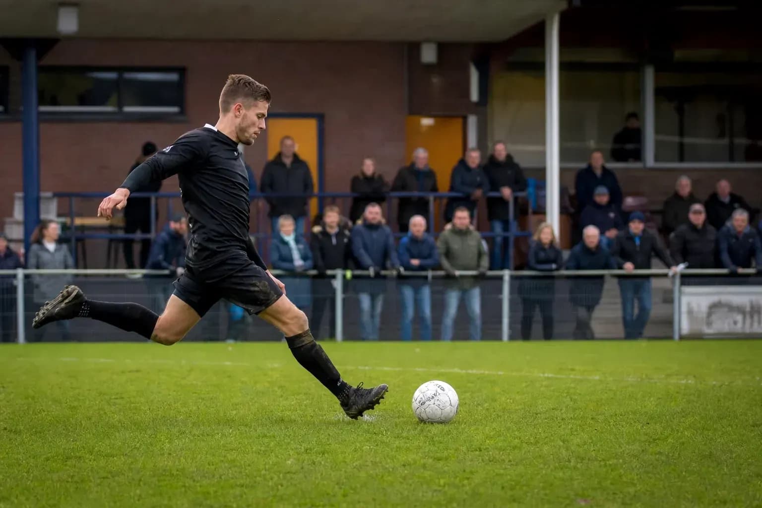 Player kicking a soccer ball during match Player kicking a soccer ball during match