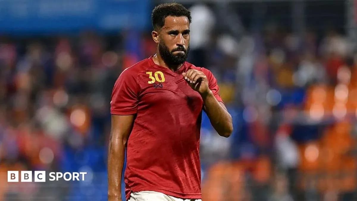 Player wearing red jersey walking on the field Player wearing red jersey walking on the field