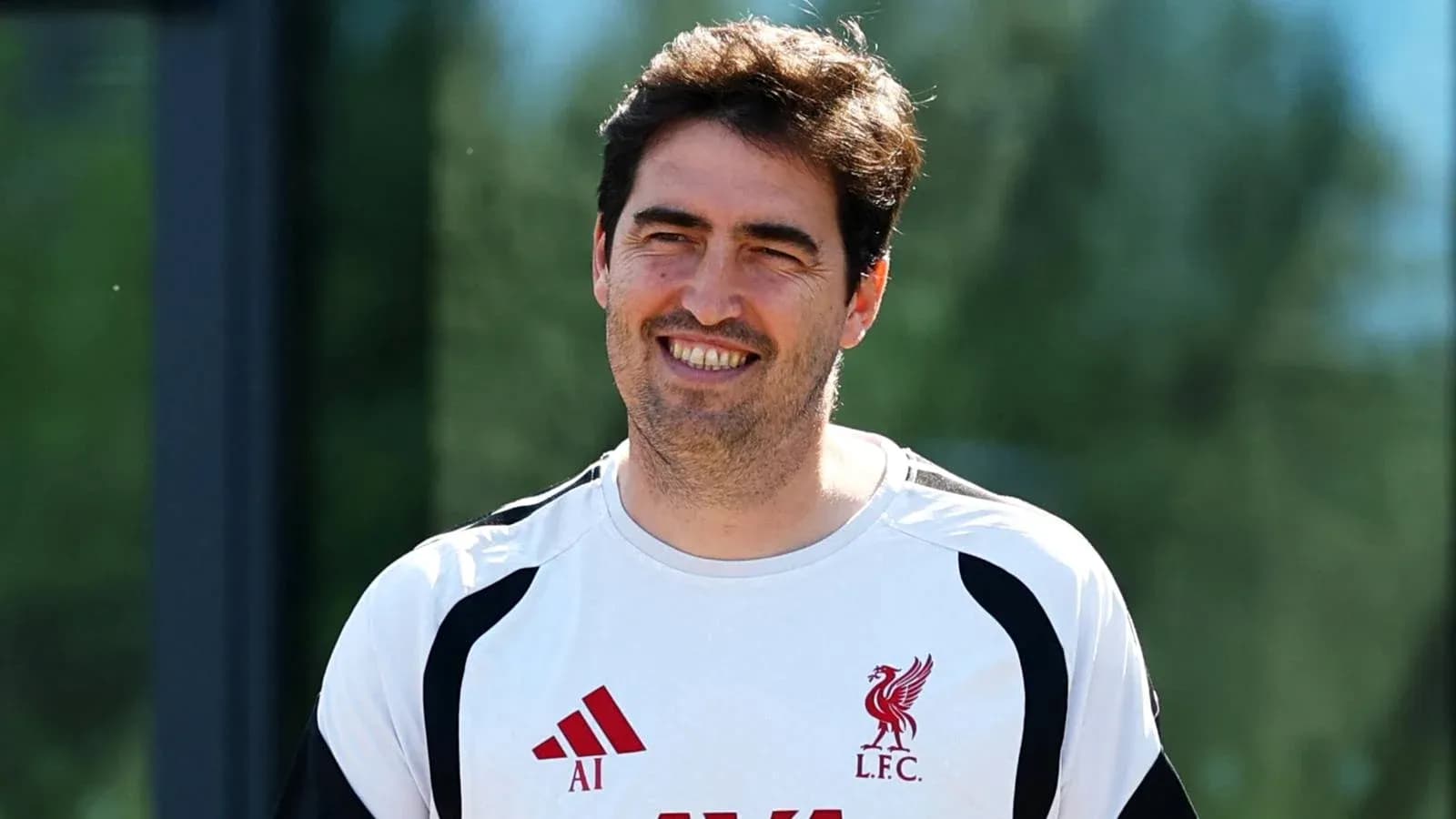 Coach wearing Liverpool kit during training session Coach wearing Liverpool kit during training session