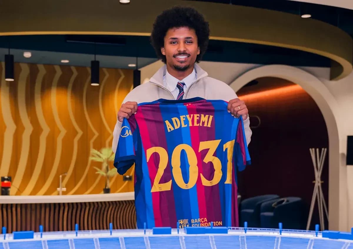 Player holding Barcelona jersey with 'Adeyemi' and '2031' Player holding Barcelona jersey with 'Adeyemi' and '2031'