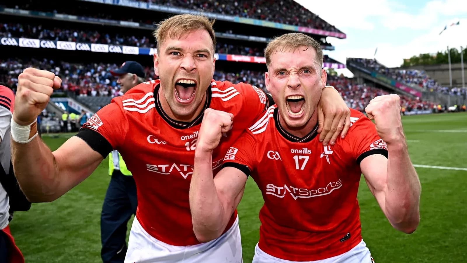 Two players celebrating in red jerseys after victory Two players celebrating in red jerseys after victory