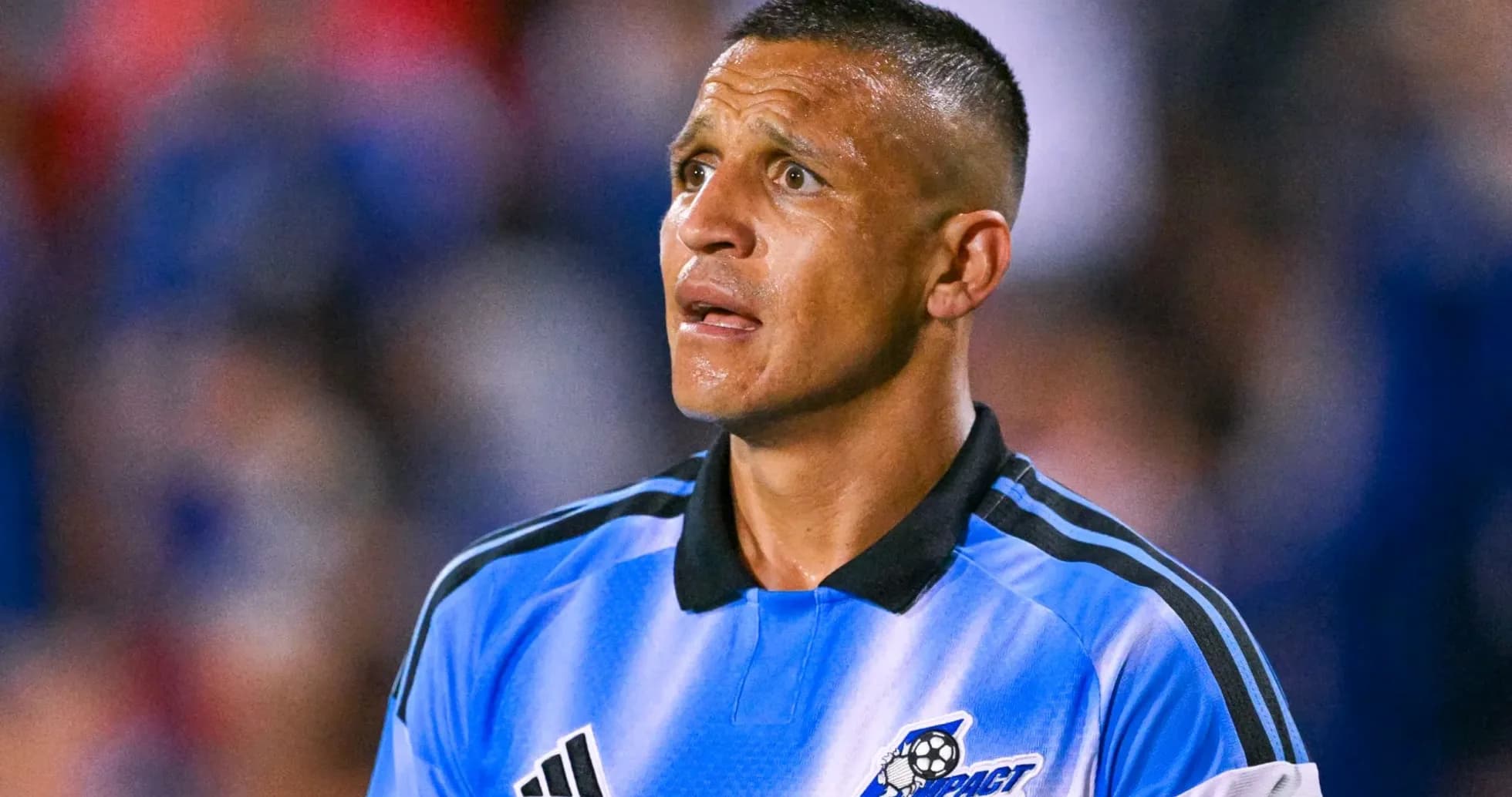 Player in blue jersey looking up during match Player in blue jersey looking up during match