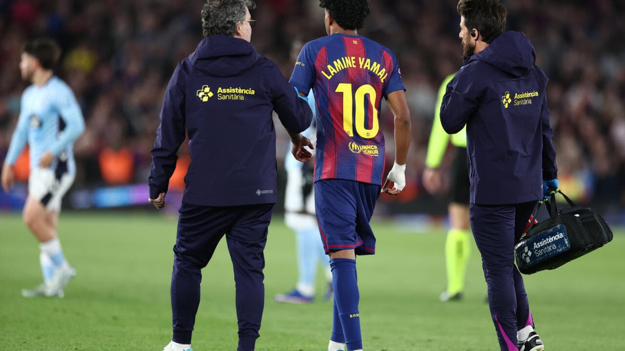 Lamine Yamal being assisted off the pitch by staff Lamine Yamal being assisted off the pitch by staff