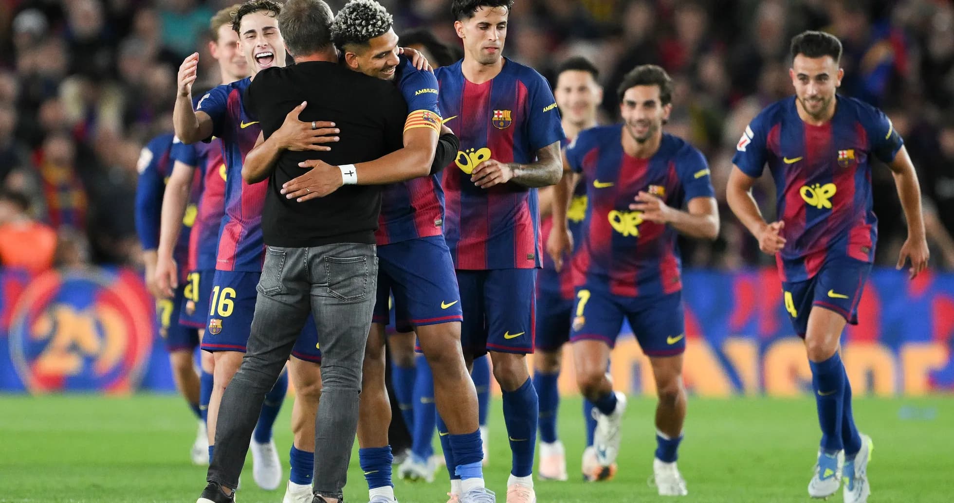 Barcelona players celebrating a victory on the field Barcelona players celebrating a victory on the field