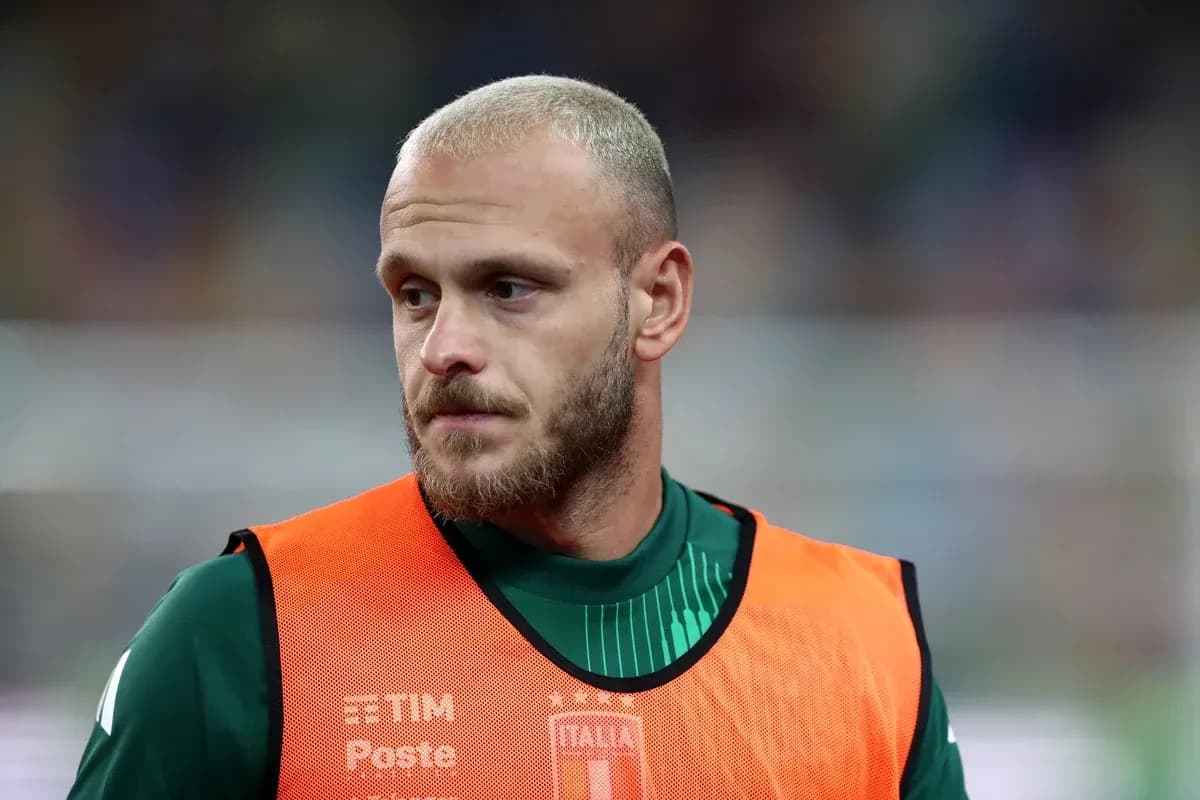 Goalkeeper wearing training vest on sidelines Goalkeeper wearing training vest on sidelines