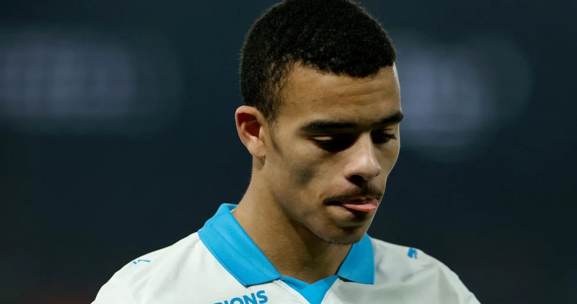 Player in Marseille jersey looking down thoughtfully Player in Marseille jersey looking down thoughtfully