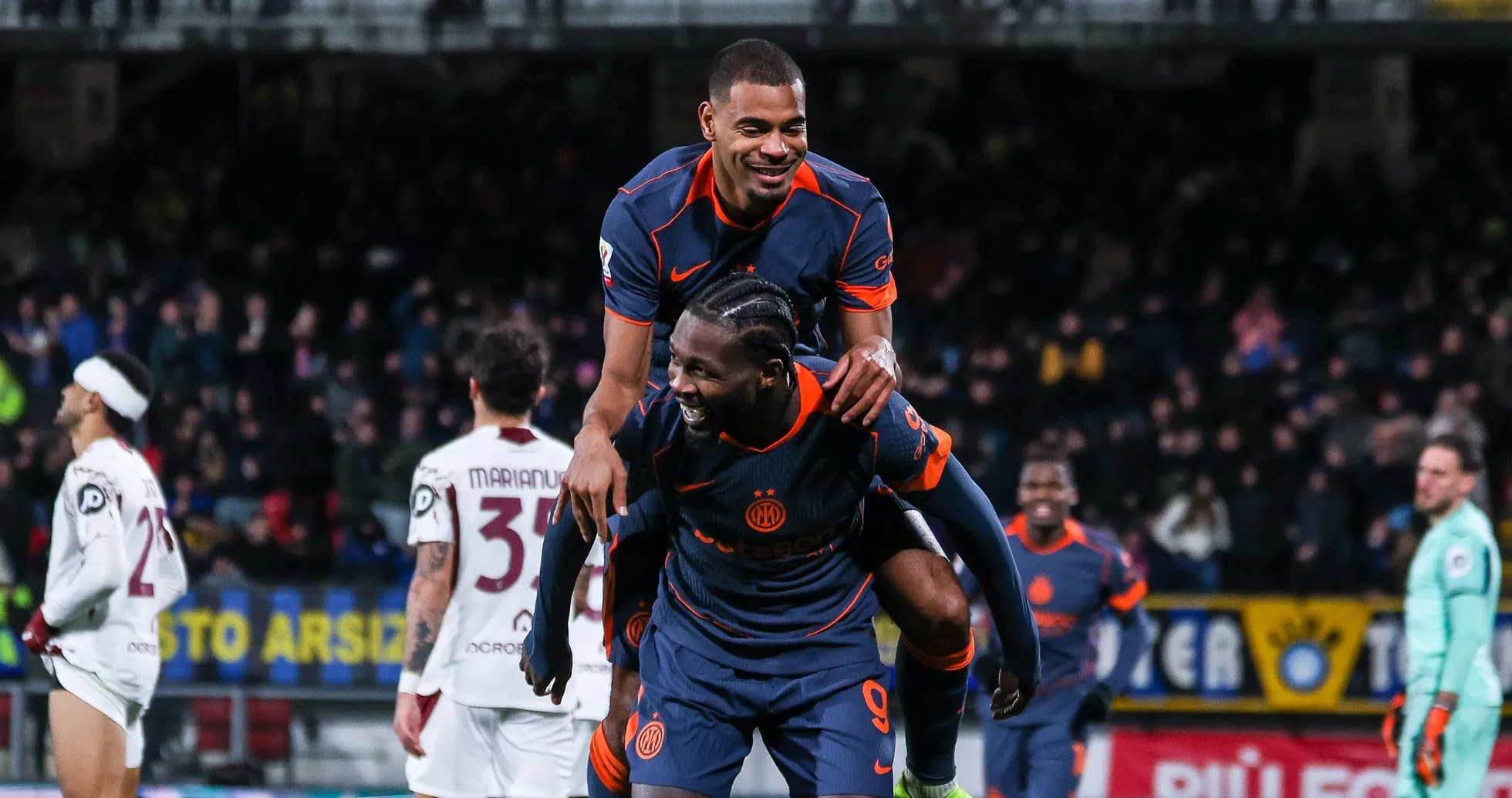 Two players celebrating a goal on the field Two players celebrating a goal on the field