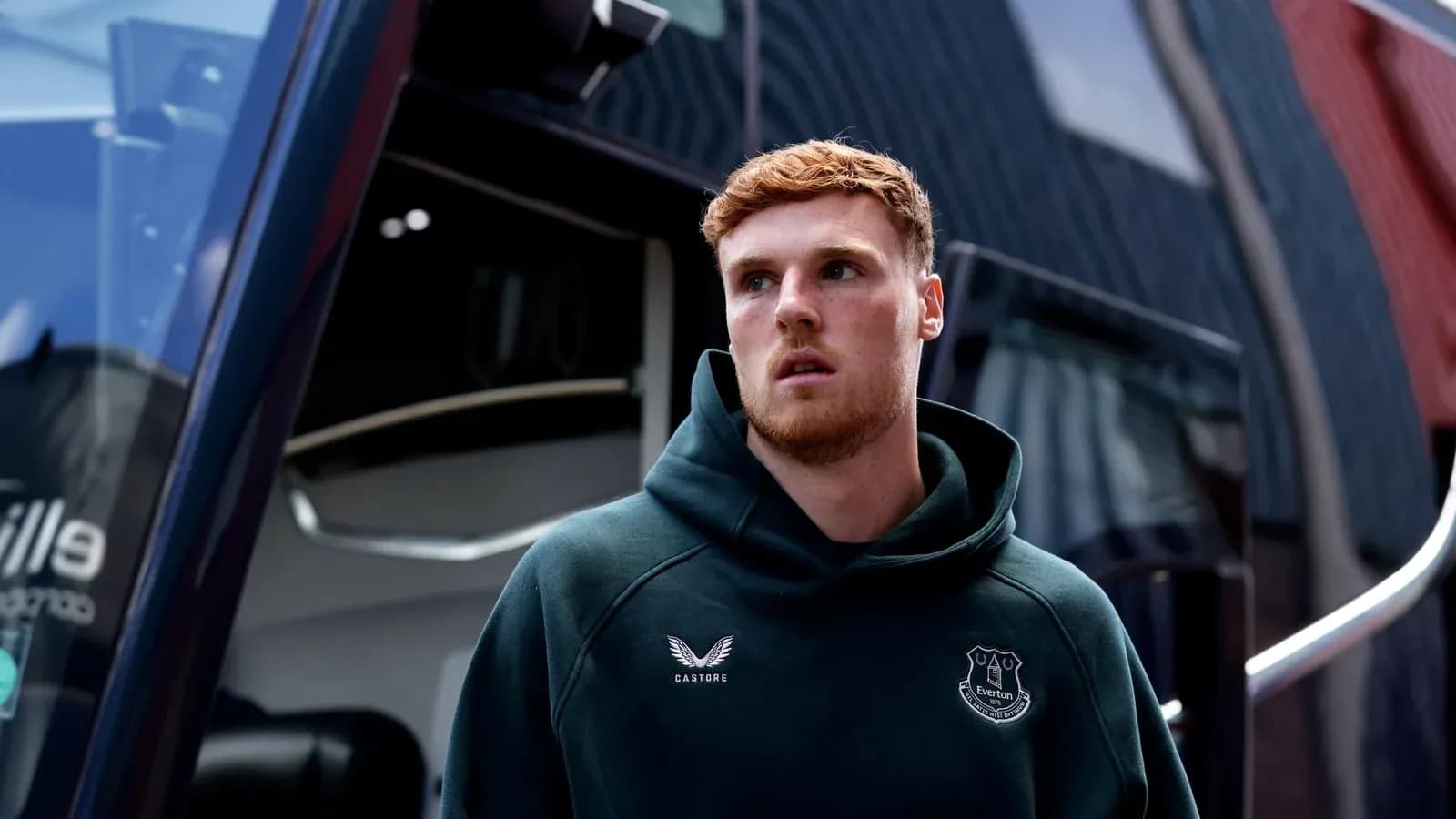 Player in Everton hoodie outside team bus Player in Everton hoodie outside team bus