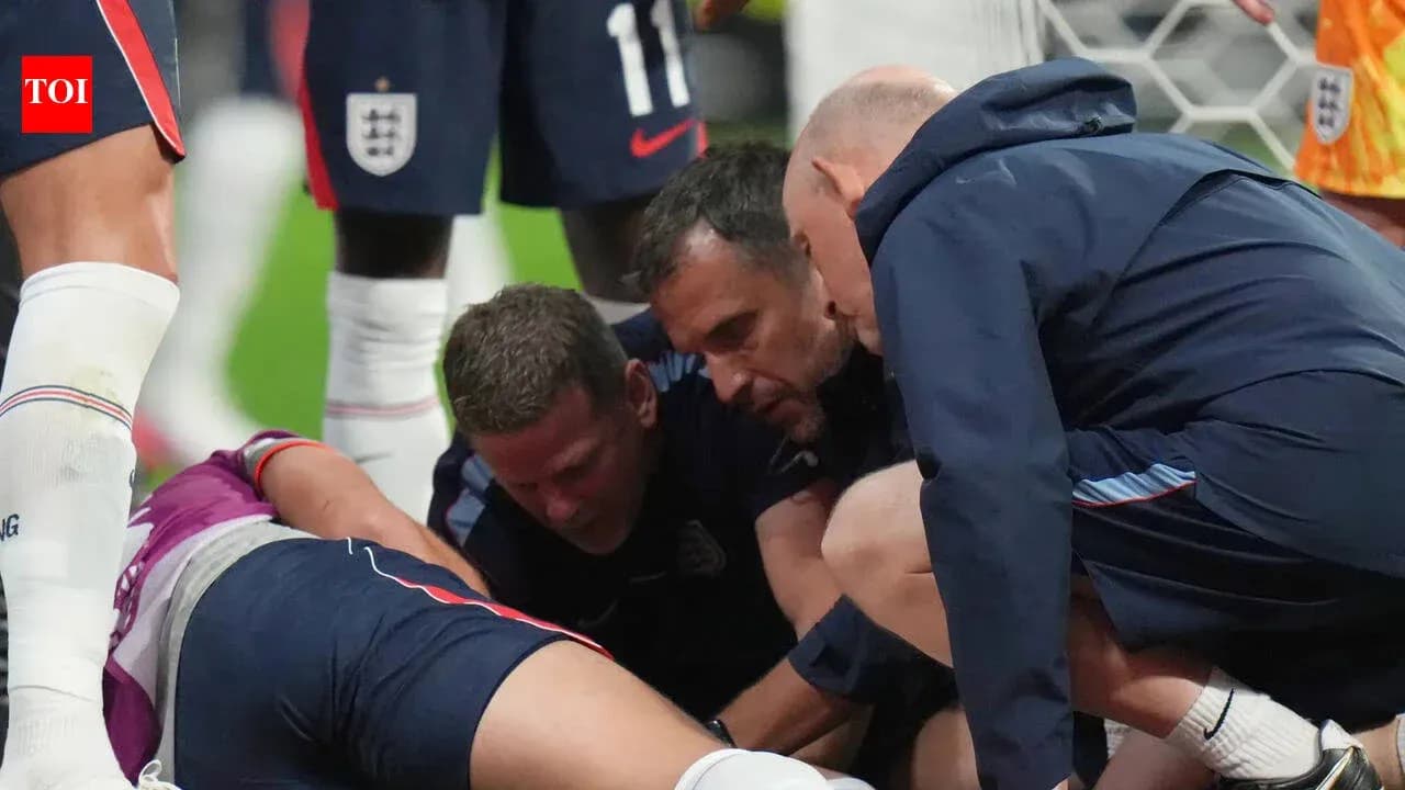 Coaches attending to injured player on the field Coaches attending to injured player on the field