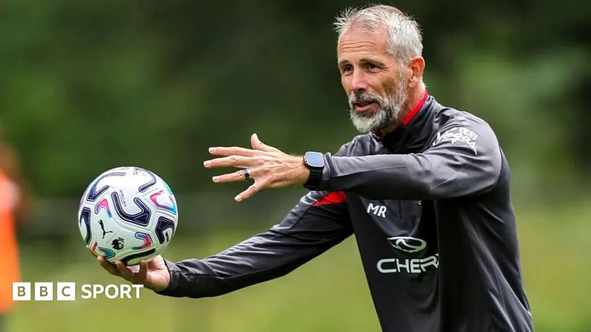 Coach demonstrating a drill with a football Coach demonstrating a drill with a football