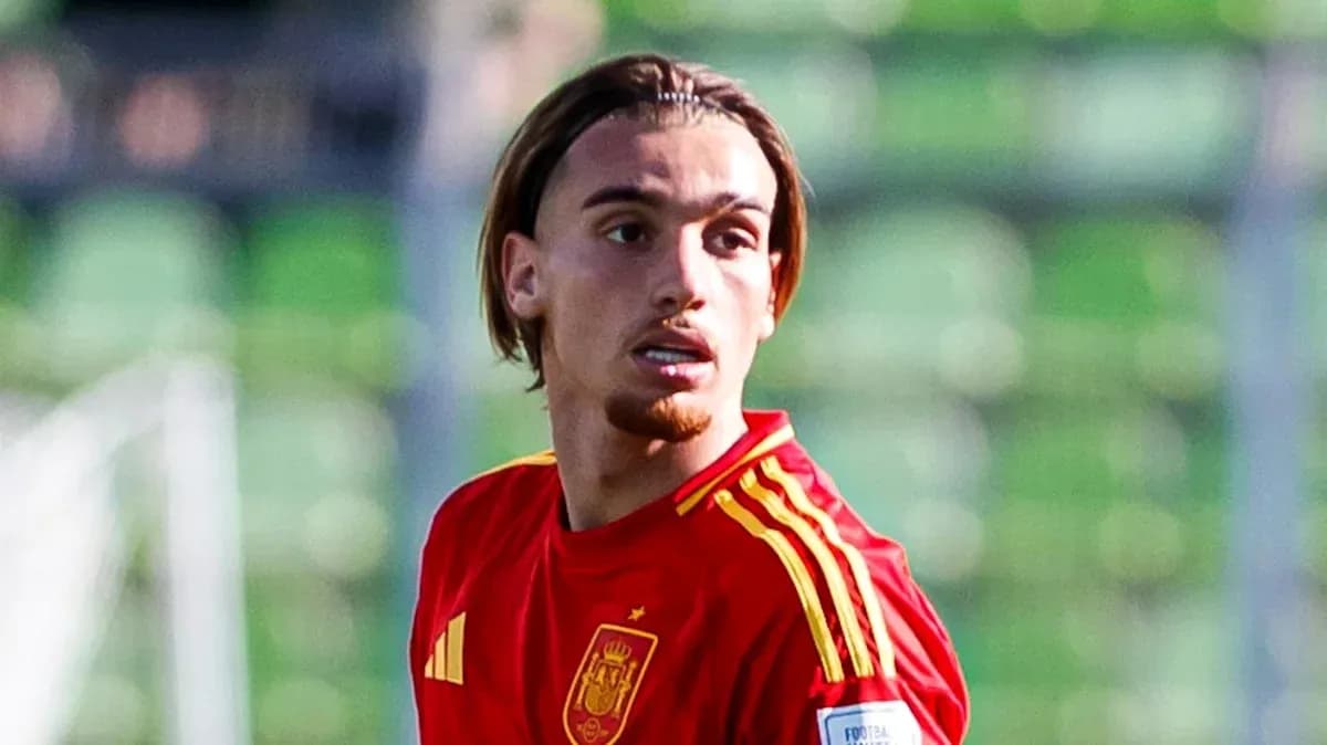 Player in red Spain jersey on the field Player in red Spain jersey on the field