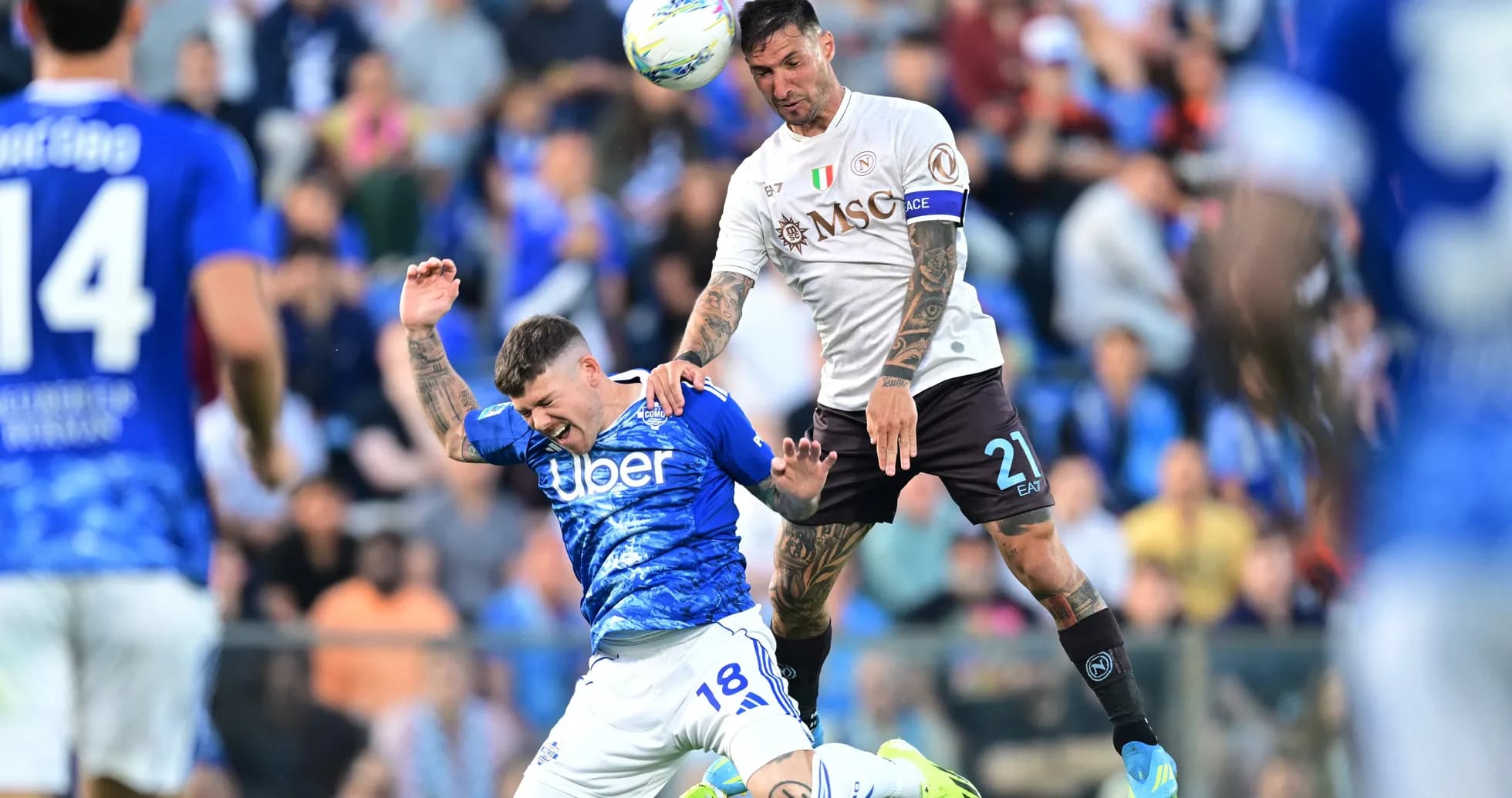Napoli player challenging Como player for the ball Napoli player challenging Como player for the ball