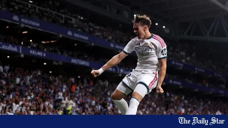 Player celebrating a goal in stadium with fans Player celebrating a goal in stadium with fans
