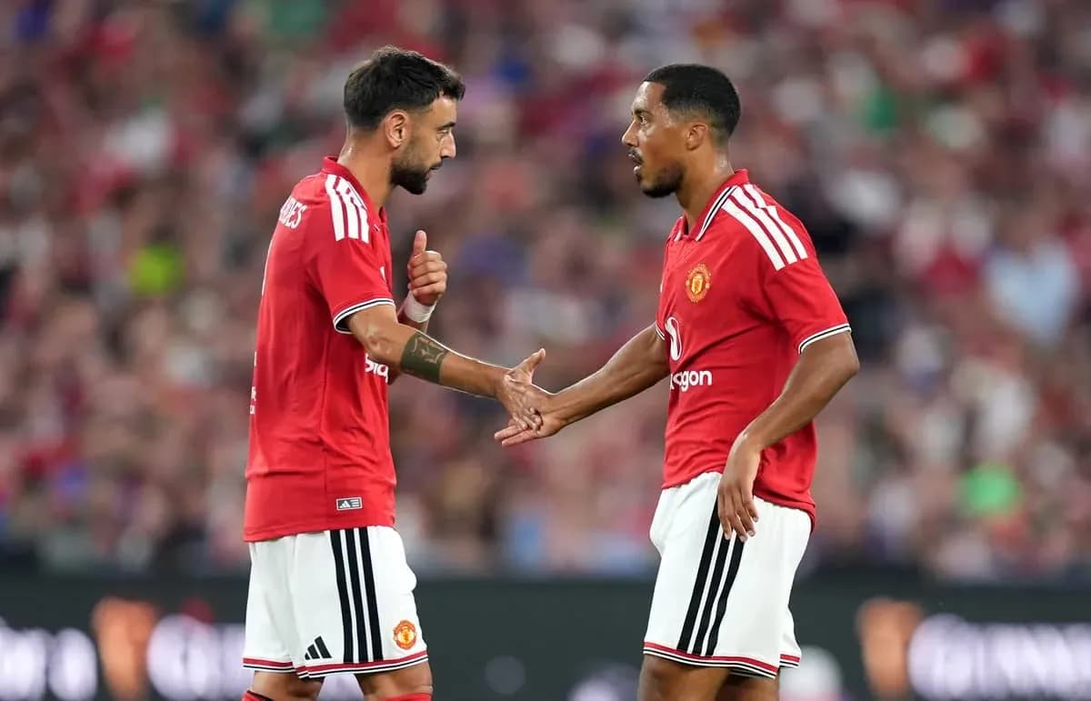 Two Manchester United players discussing on the pitch Two Manchester United players discussing on the pitch