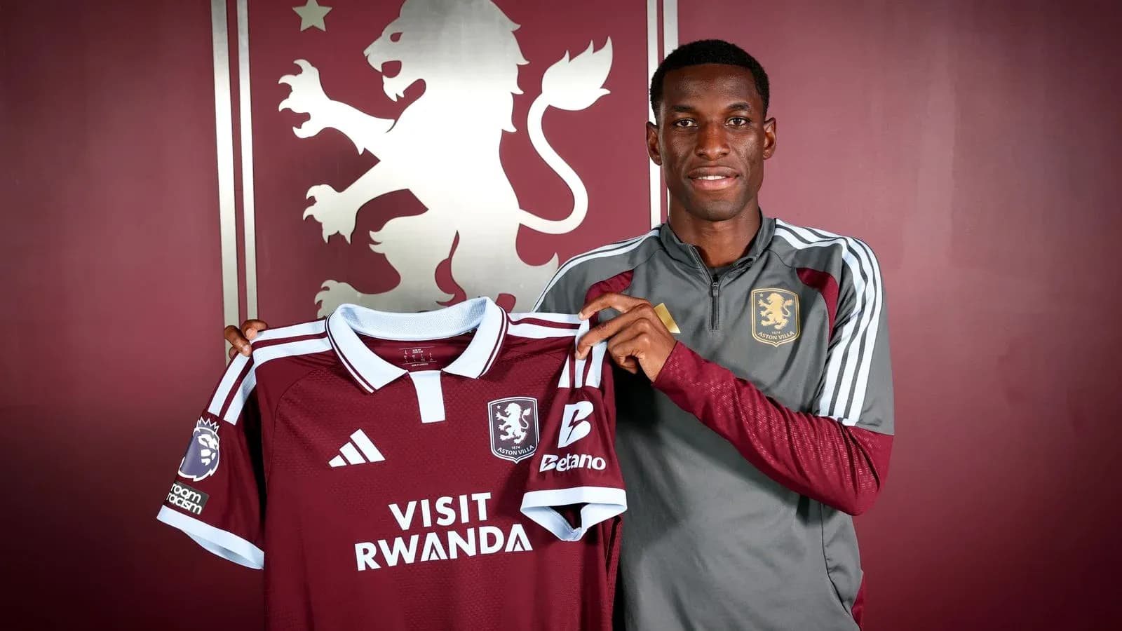 Player holding Aston Villa jersey during announcement Player holding Aston Villa jersey during announcement