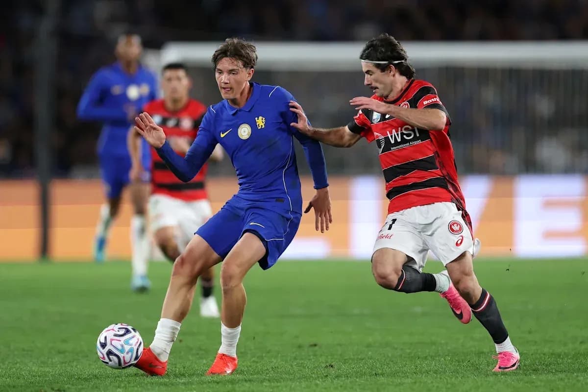Player in blue evading a tackle from opponent in red Player in blue evading a tackle from opponent in red