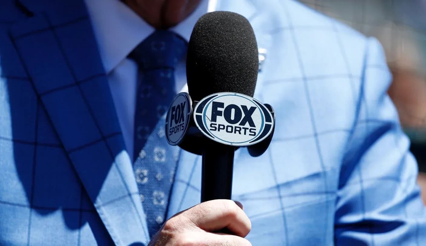 Microphone with FOX Sports logo held by person Microphone with FOX Sports logo held by person