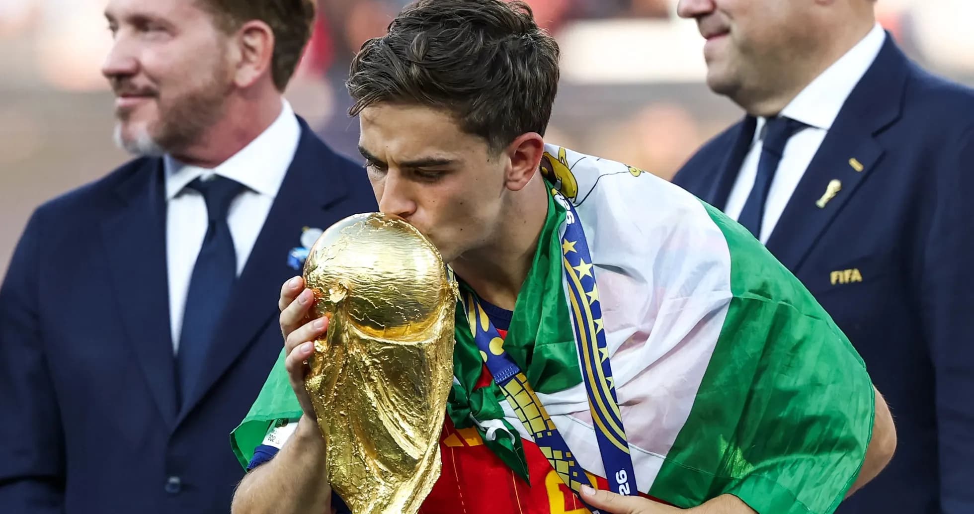Player kissing the World Cup trophy on podium Player kissing the World Cup trophy on podium