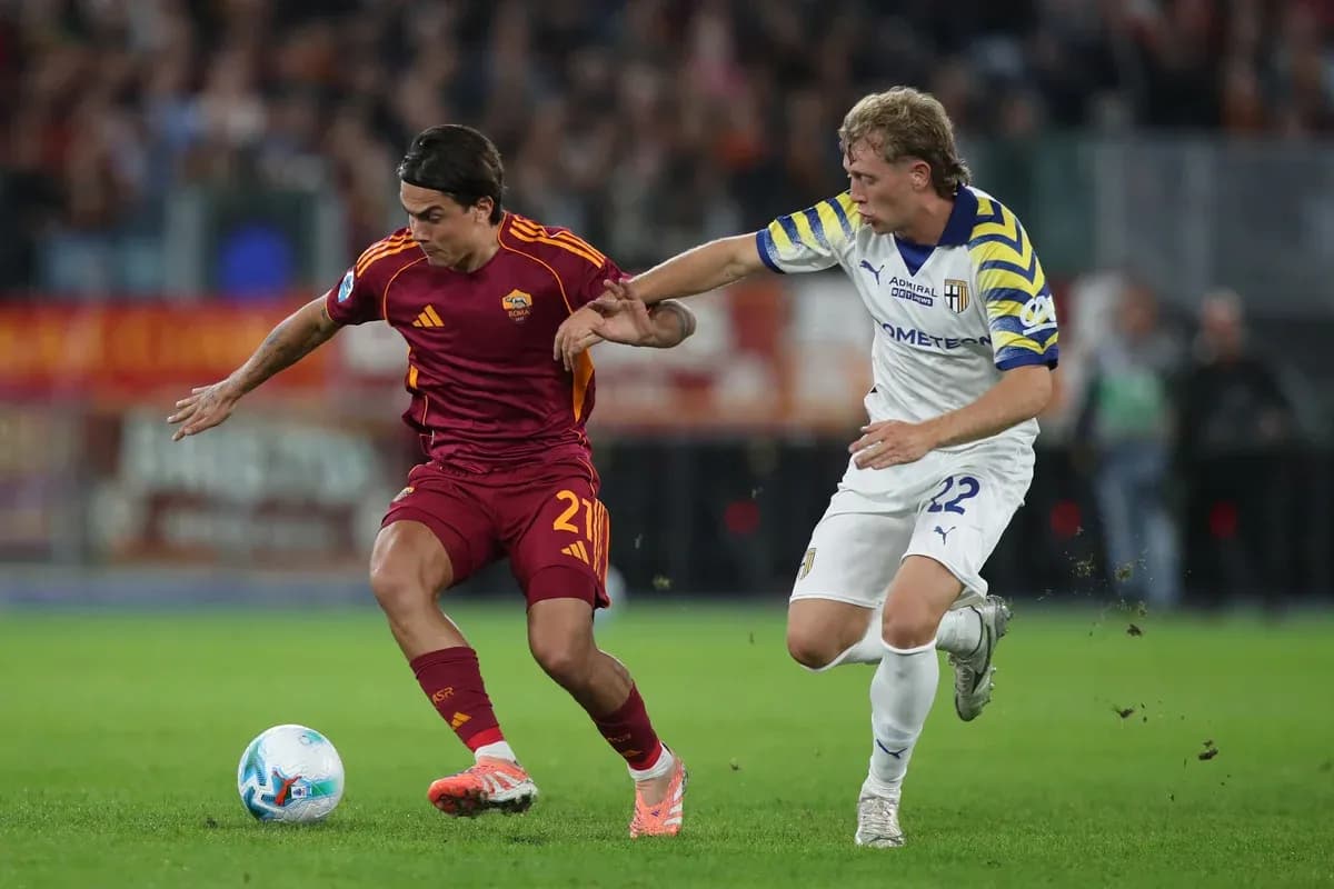 AS Roma player dribbling against Parma player AS Roma player dribbling against Parma player