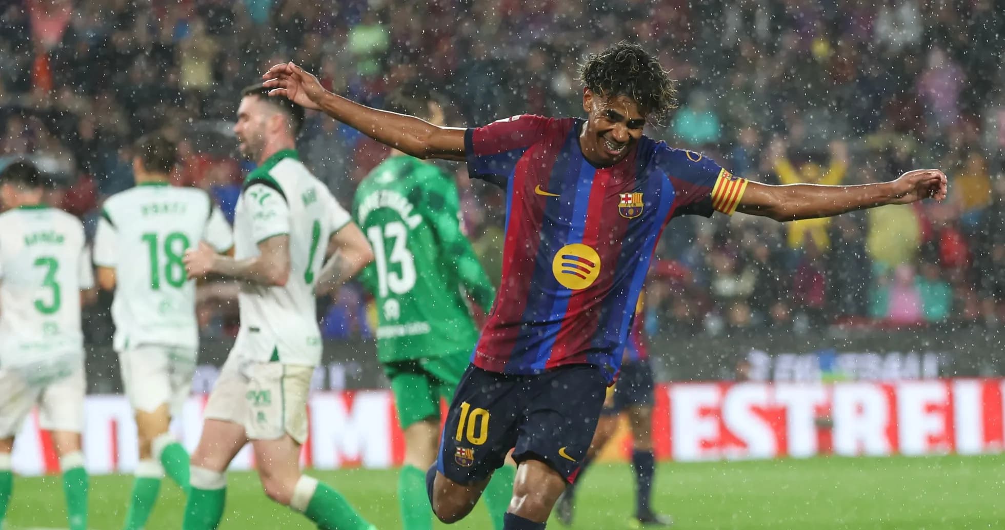 Barcelona player celebrating goal in heavy rain Barcelona player celebrating goal in heavy rain