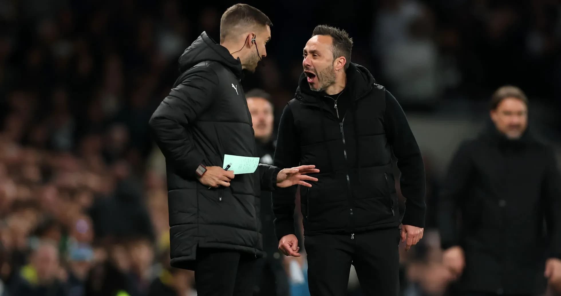Coaches discussing during a tense moment on the sidelines Coaches discussing during a tense moment on the sidelines