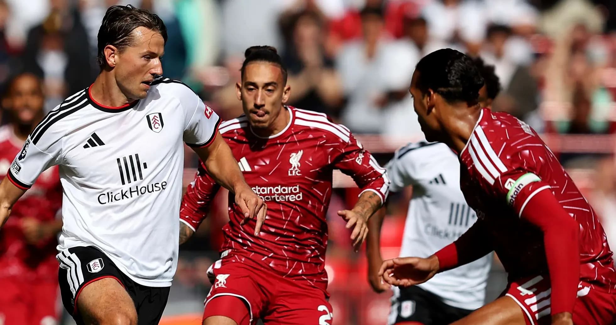 Liverpool and Fulham players competing for the ball Liverpool and Fulham players competing for the ball
