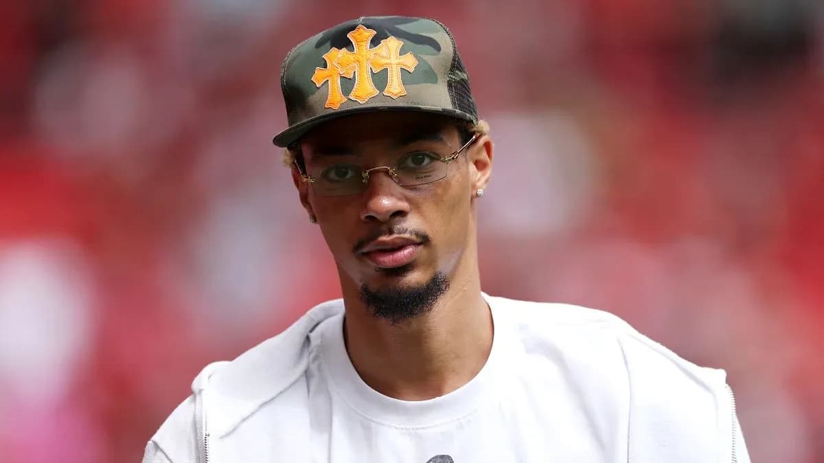 Person wearing a camo hat and glasses Person wearing a camo hat and glasses