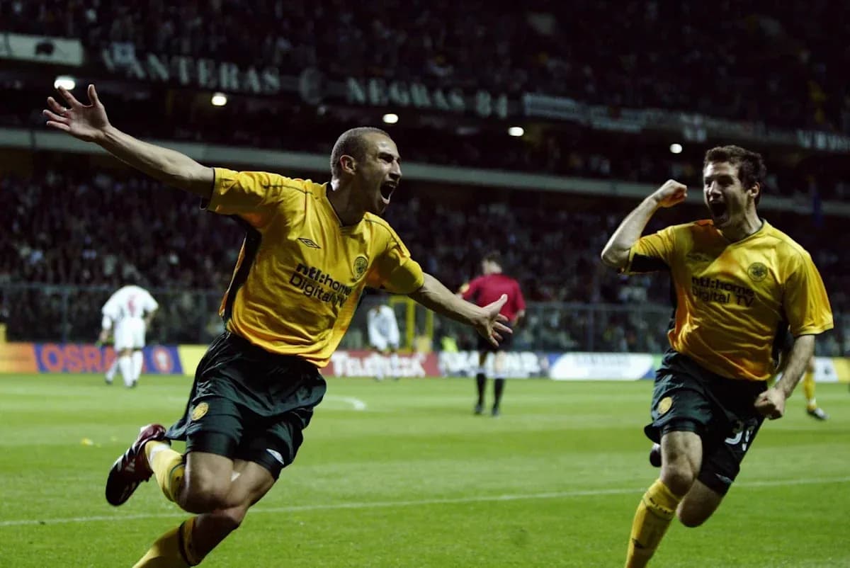 Two players celebrating a goal on the pitch Two players celebrating a goal on the pitch