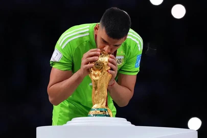 Goalkeeper kissing FIFA World Cup trophy on podium Goalkeeper kissing FIFA World Cup trophy on podium
