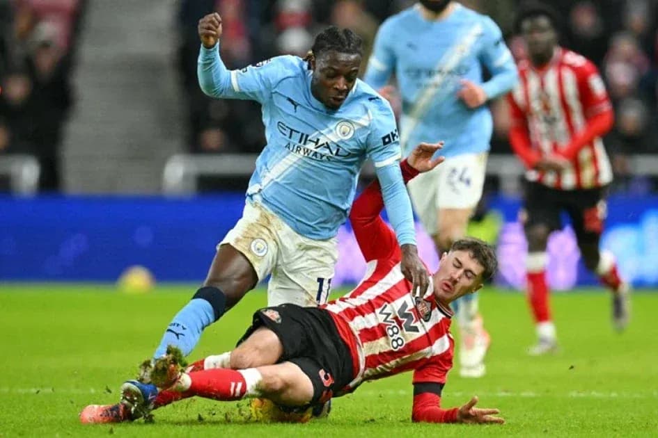 Player from Manchester City evading a tackle Player from Manchester City evading a tackle