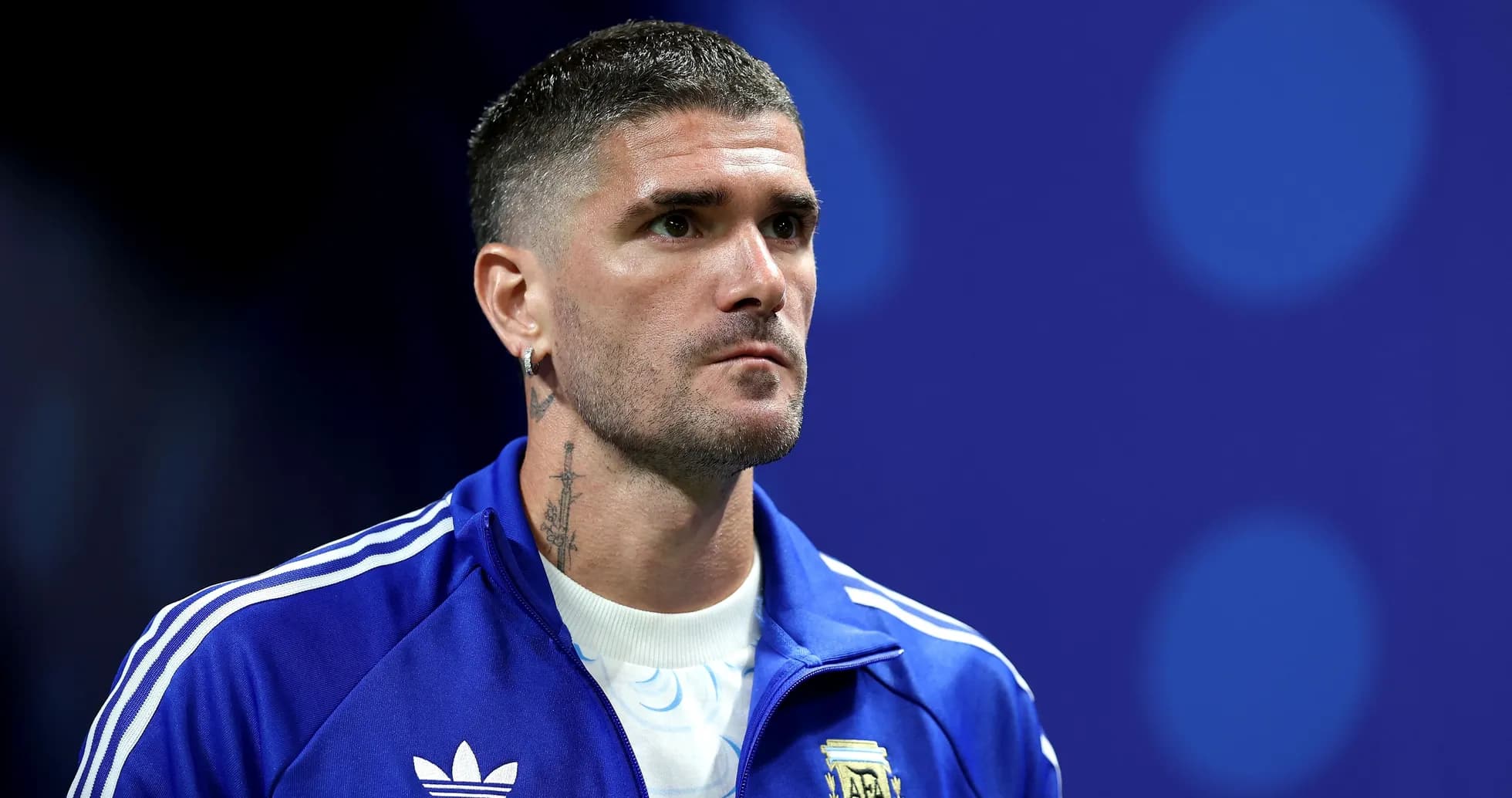 Player wearing blue jacket during pre-match event Player wearing blue jacket during pre-match event